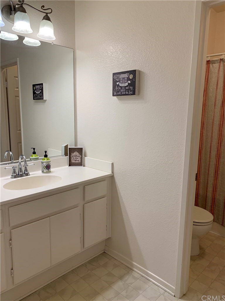 24817 Butterchurn Road Wildomar, CA 92595 - Photo 22 of 39 Hall bath has a convenient separation to allow for a private shower while someone else uses the sink/vanity area.