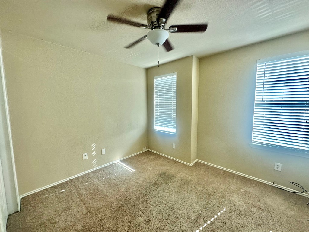2624 Haselwood Lane Round Rock, TX 78665 - Photo 15 of 20 an empty room with a window and a fan