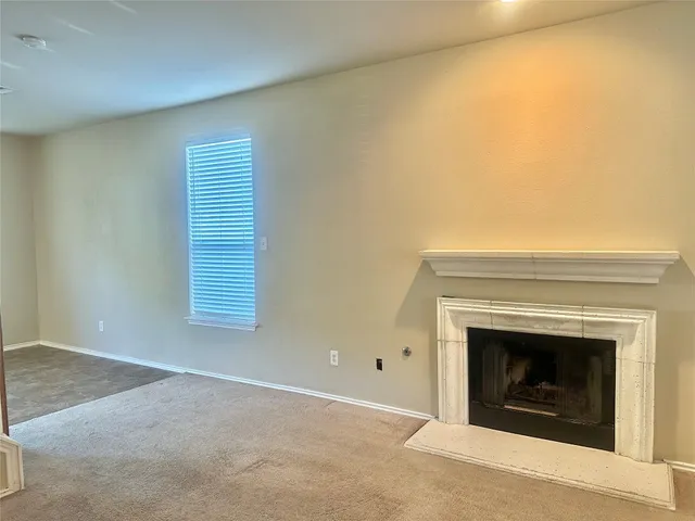 a view of an empty room with a fireplace