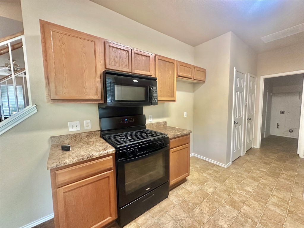 2624 Haselwood Lane Round Rock, TX 78665 - Photo 5 of 20 a kitchen with a stove and a microwave