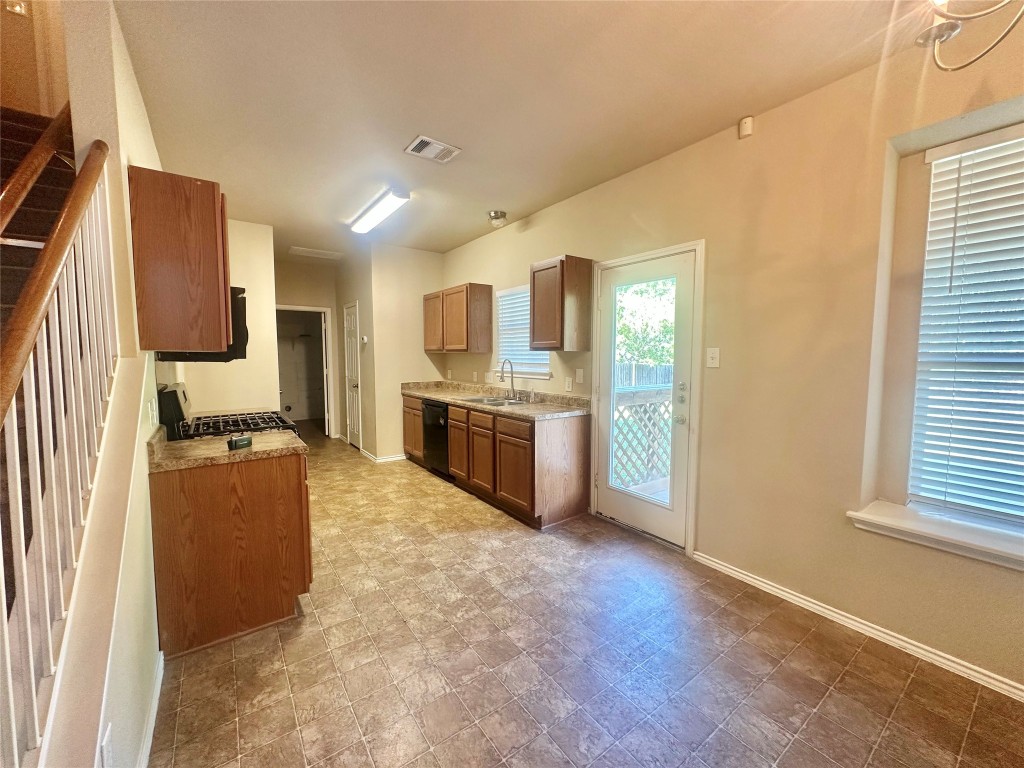 2624 Haselwood Lane Round Rock, TX 78665 - Photo 6 of 20 a kitchen with stainless steel appliances granite countertop a stove a sink and a refrigerator