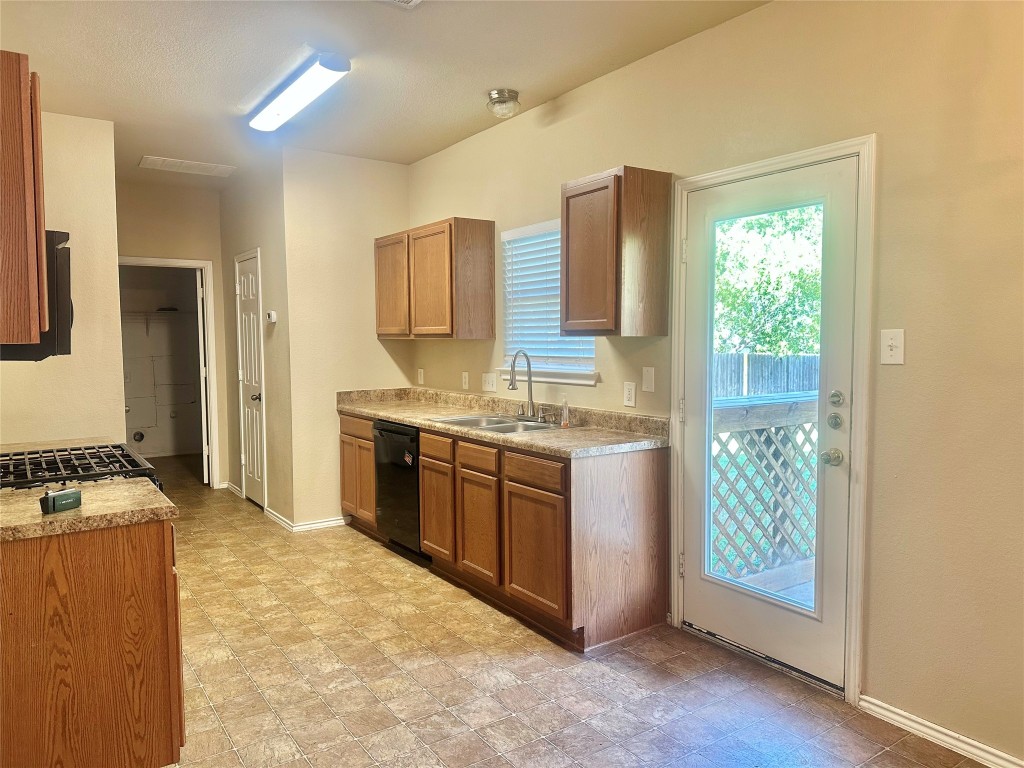 2624 Haselwood Lane Round Rock, TX 78665 - Photo 7 of 20 a kitchen with stainless steel appliances granite countertop a stove a sink and a refrigerator