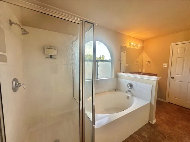 a bathroom with a tub and shower