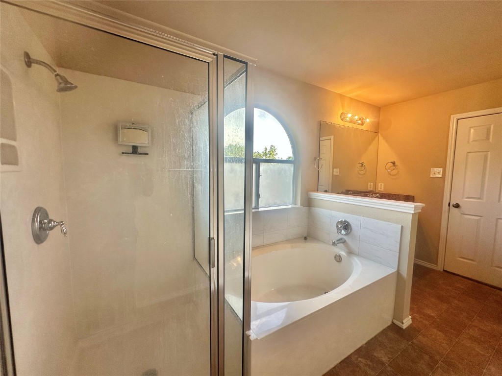 2624 Haselwood Lane Round Rock, TX 78665 - Photo 9 of 20 a bathroom with a tub and shower