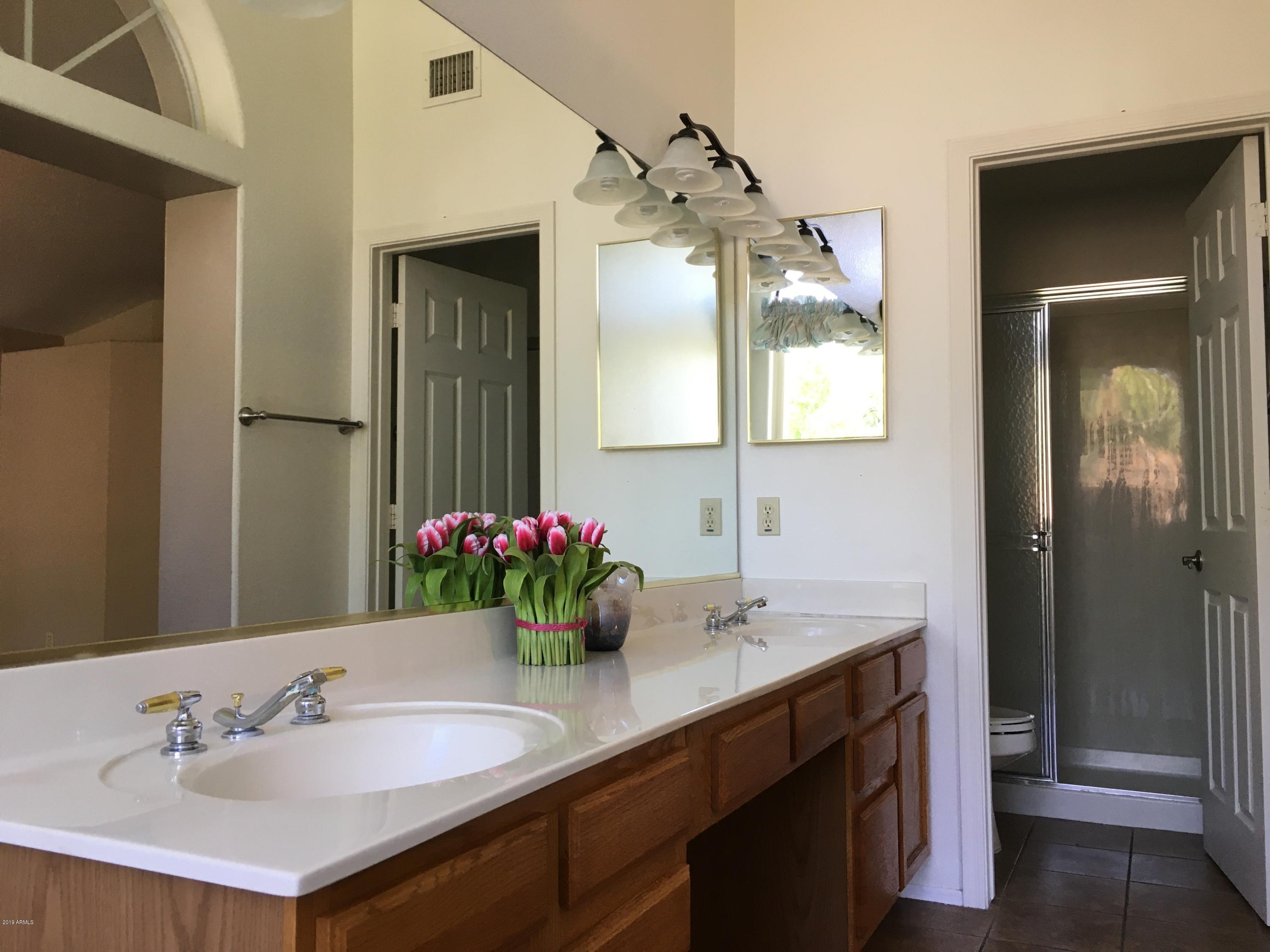 5956 East Phelps Road Scottsdale, AZ 85254 - Photo 23 of 29 a bathroom with a sink vanity and a mirror