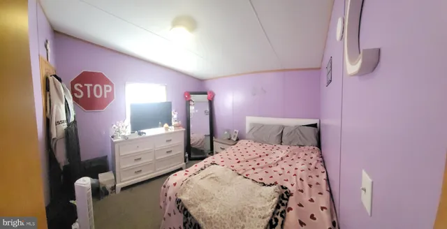 a bedroom with a bed and a table