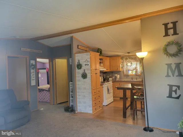 a view of kitchen with furniture and refrigerator