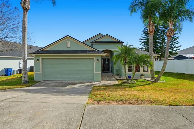 a front view of house with yard and swimming pool