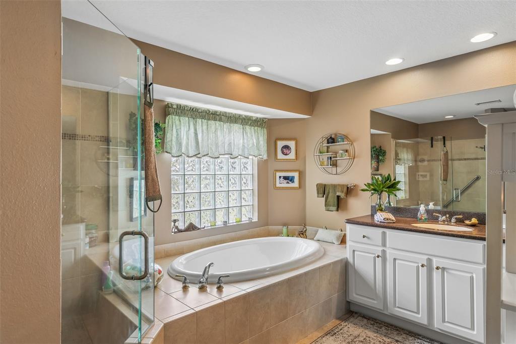 3757 Countryside Road Sarasota, FL 34233 - Photo 25 of 34 a bathroom with a tub sink and mirror