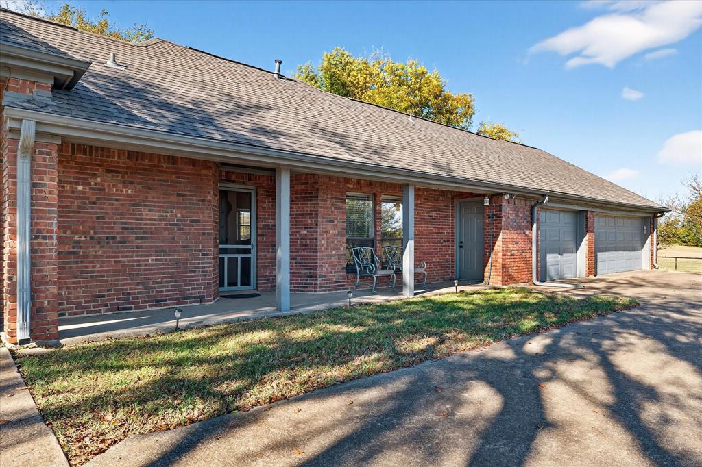 1500 Eden Ridge Celina, TX 75009 - Photo 24 of 40 a view of a brick house with large windows and a yard