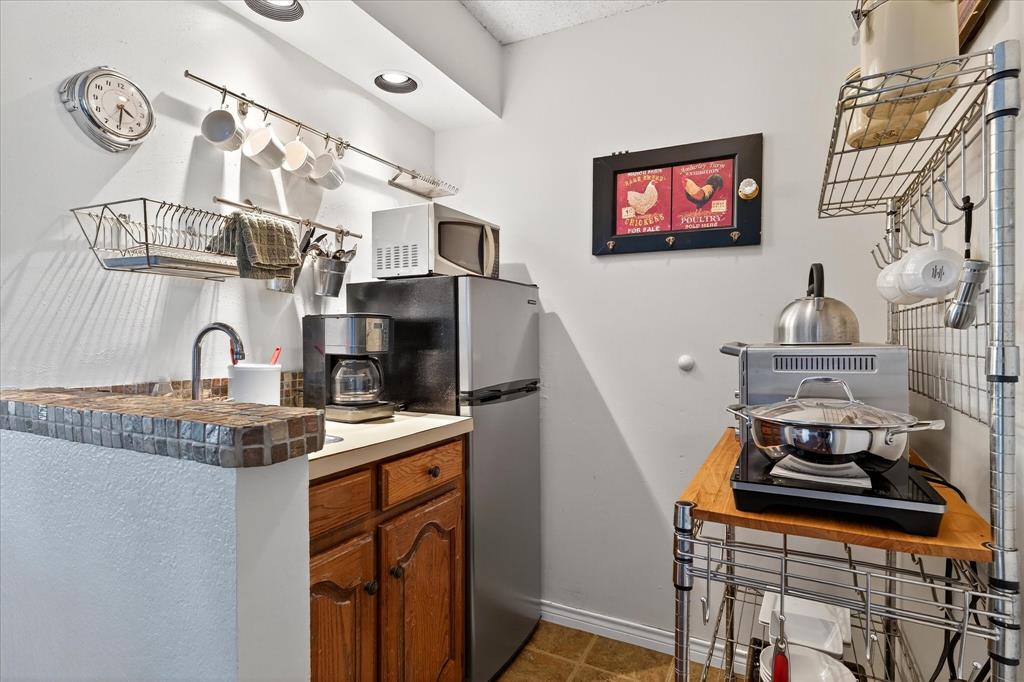 1500 Eden Ridge Celina, TX 75009 - Photo 26 of 40 a kitchen with stainless steel appliances granite countertop a sink stove and cabinets