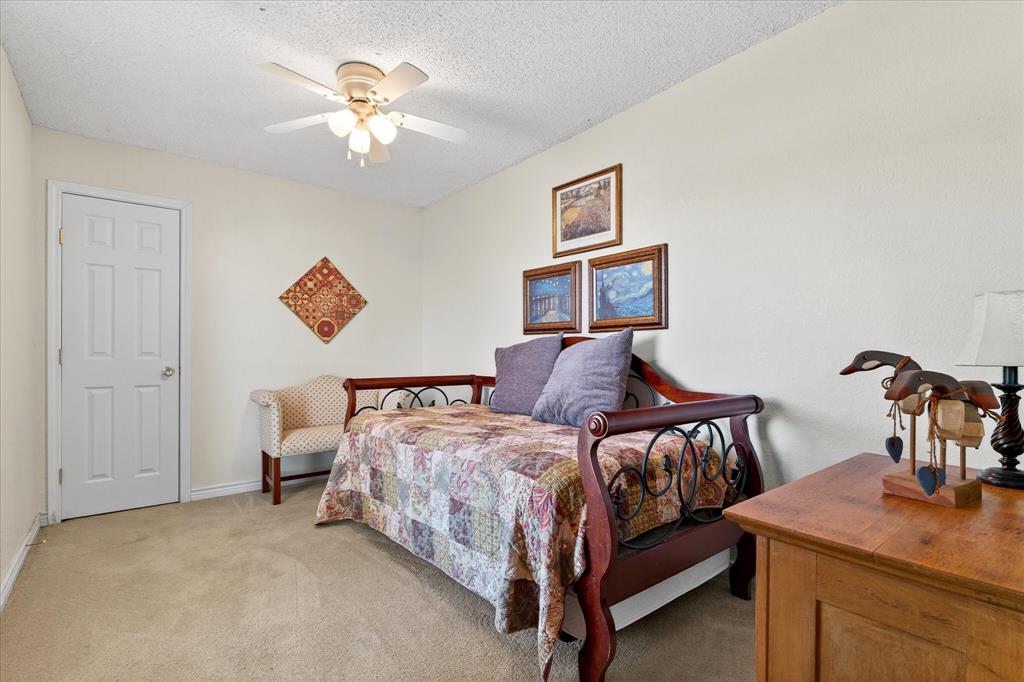 1500 Eden Ridge Celina, TX 75009 - Photo 27 of 40 a bedroom with a bed and a chandelier