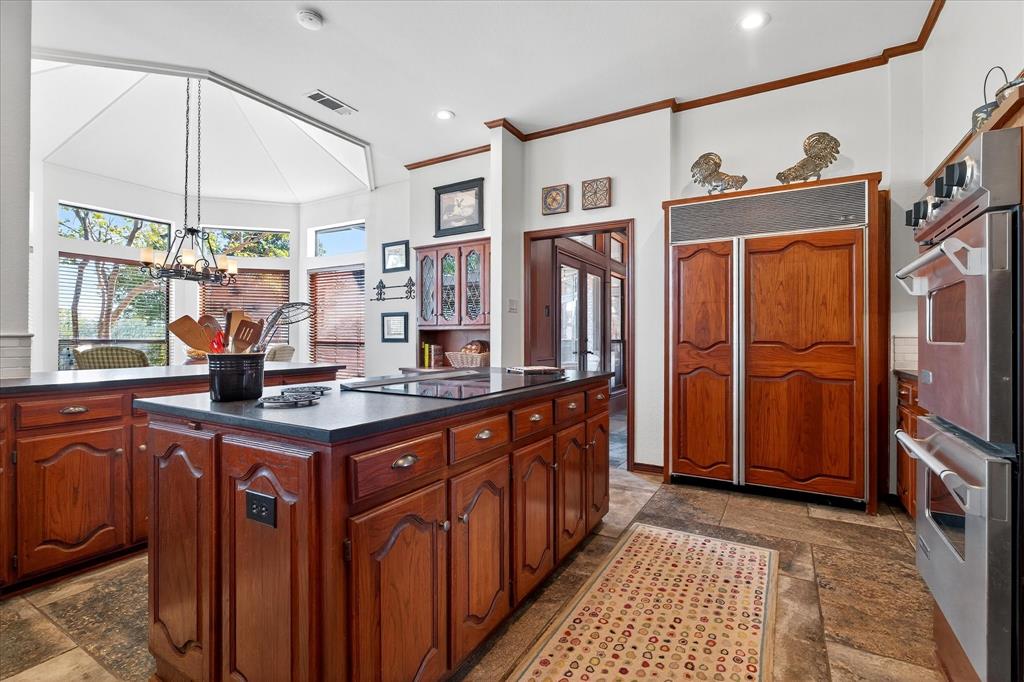 1500 Eden Ridge Celina, TX 75009 - Photo 7 of 40 a kitchen with stainless steel appliances granite countertop a stove a sink dishwasher and a refrigerator with wooden floor
