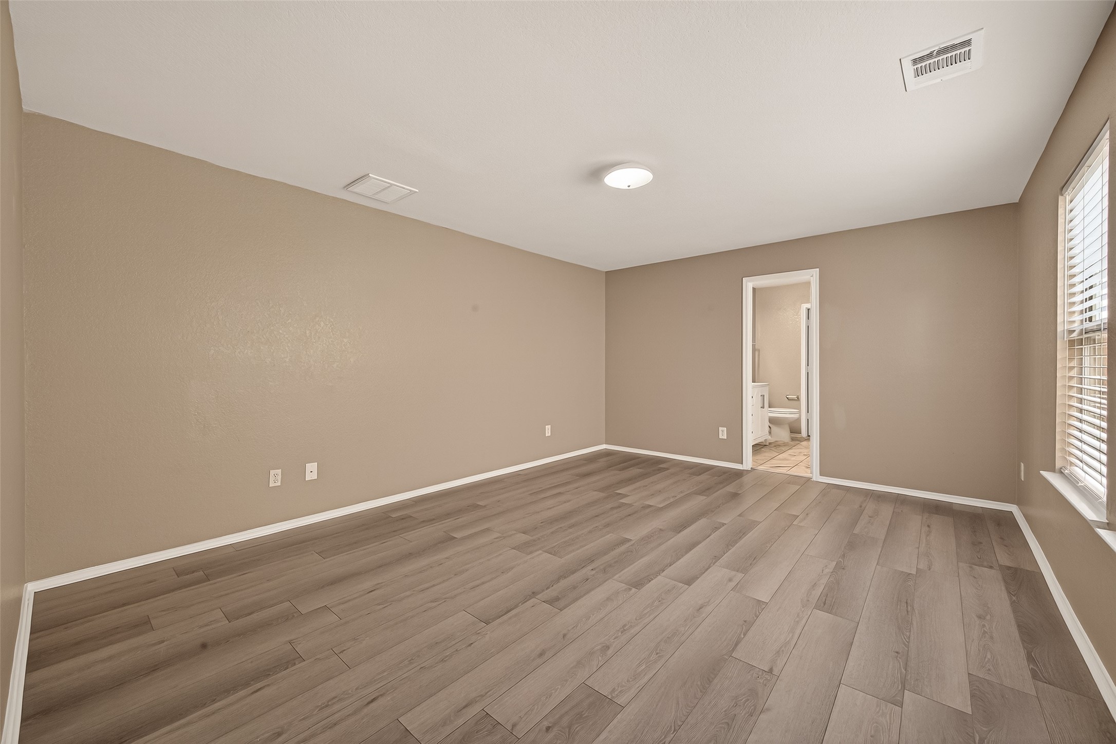 2918 Latch Lane Houston, TX 77038 - Photo 11 of 23 wooden floor in an empty room with a window