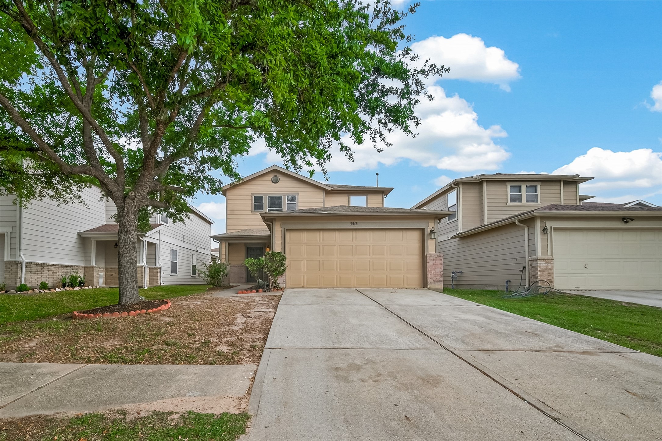 2918 Latch Lane Houston, TX 77038 - Photo 2 of 23 a front view of a house with a garden and trees