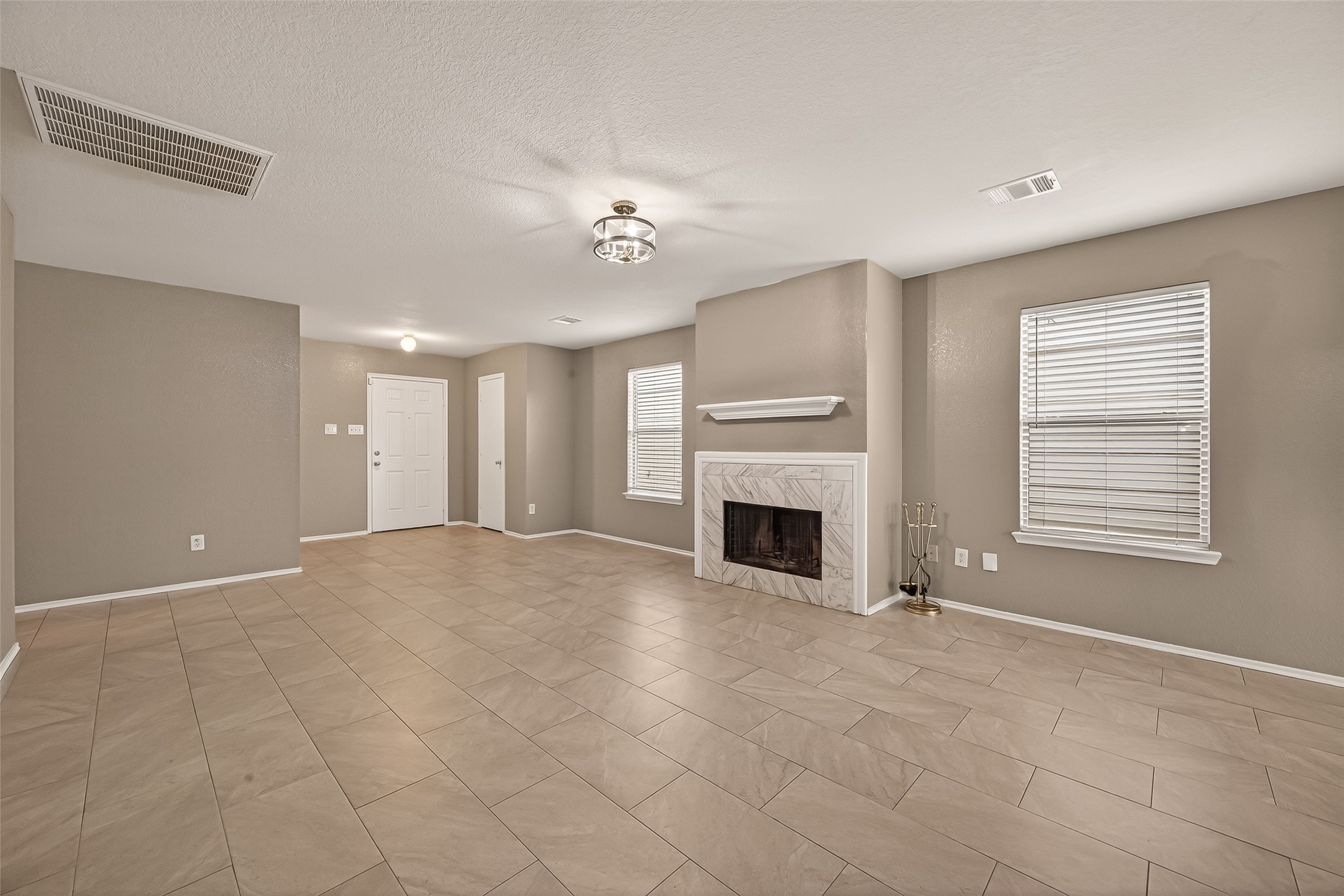 2918 Latch Lane Houston, TX 77038 - Photo 5 of 23 a view of an empty room with a fireplace and a window