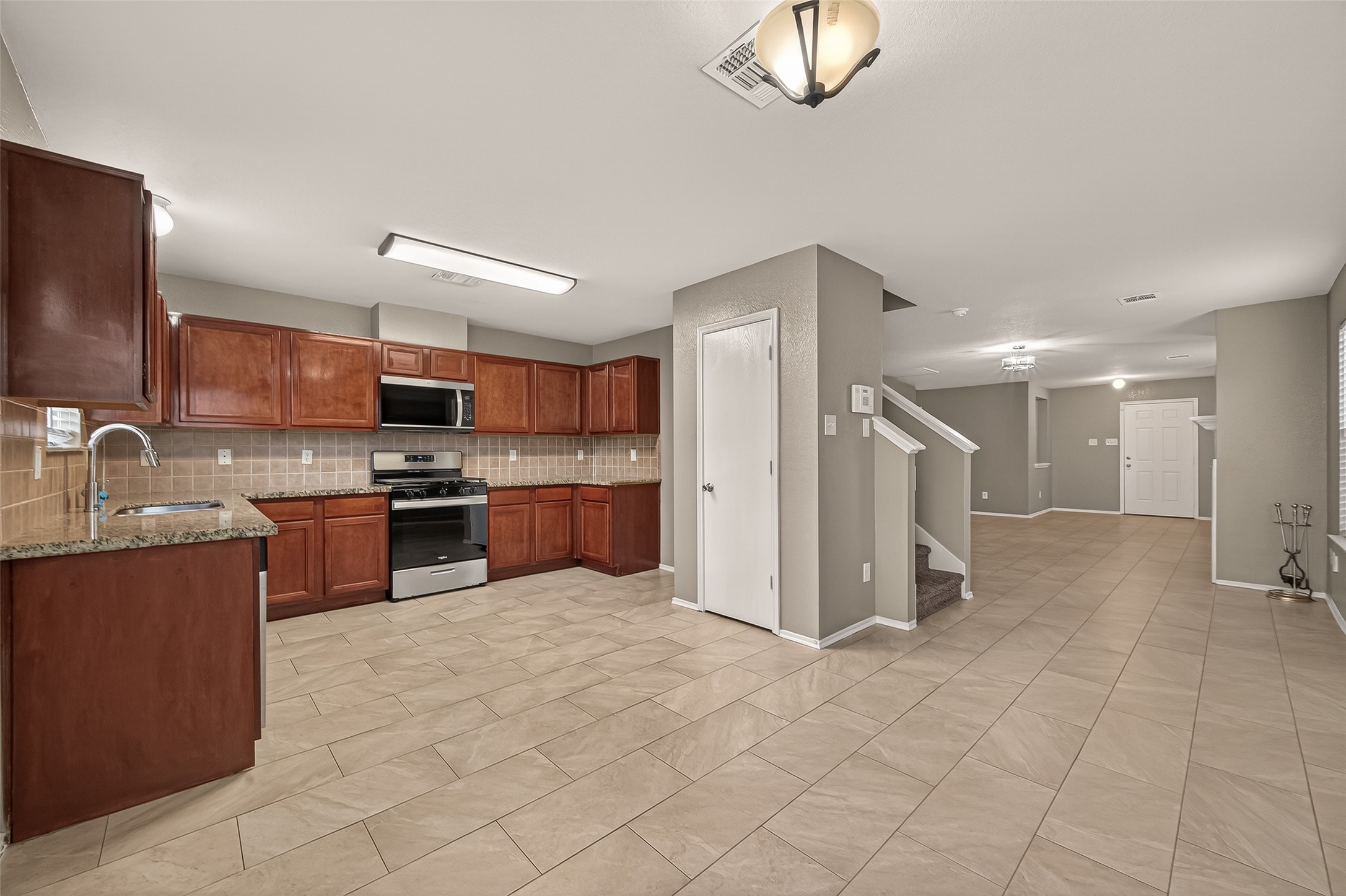 2918 Latch Lane Houston, TX 77038 - Photo 6 of 23 a large kitchen with cabinets and stainless steel appliances