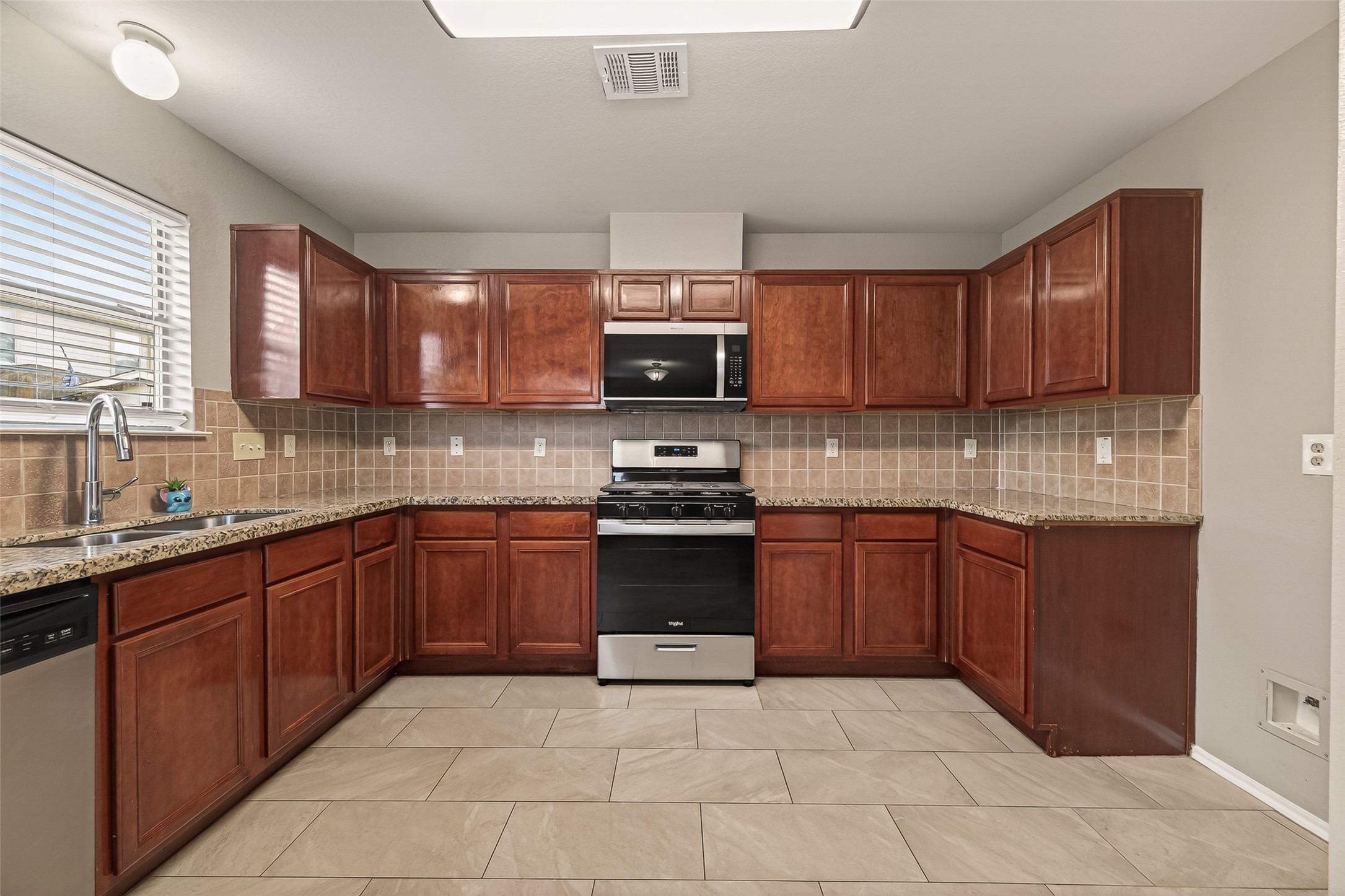 2918 Latch Lane Houston, TX 77038 - Photo 8 of 23 a kitchen with a sink and a stove top oven