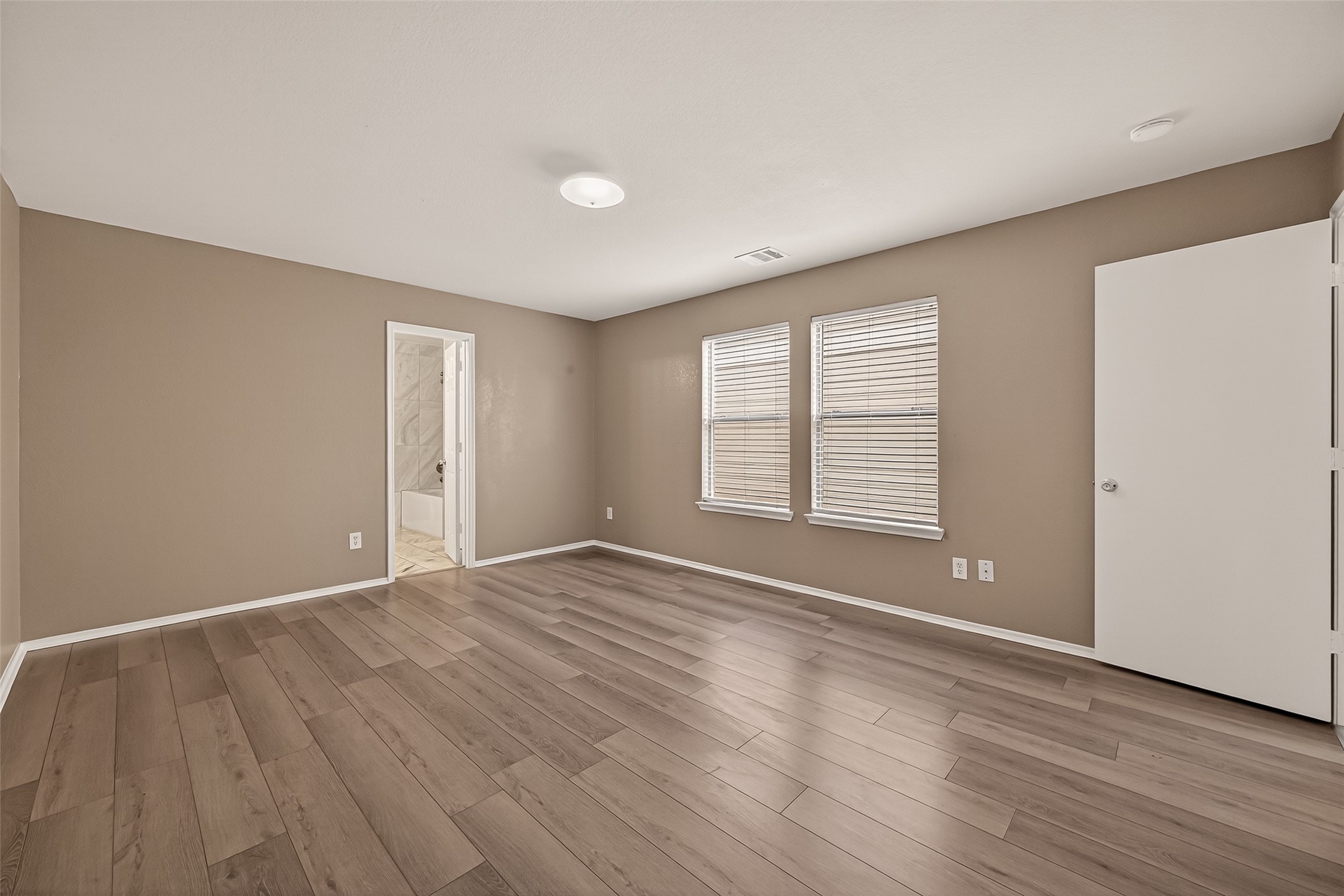 2918 Latch Lane Houston, TX 77038 - Photo 10 of 23 a view of an empty room with wooden floor and a window