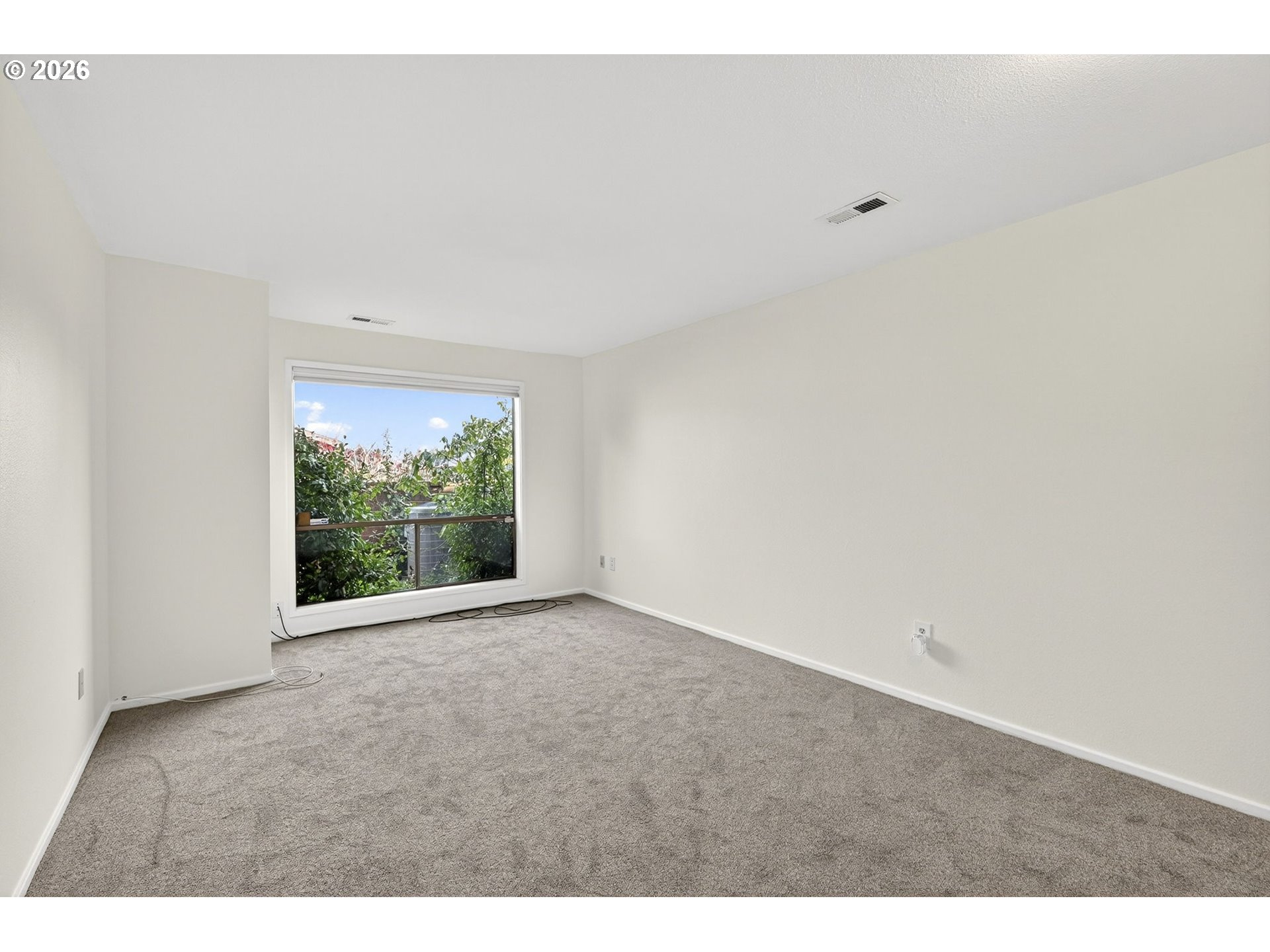 45 Southwest Condolea Court Lake Oswego, OR 97035 - Photo 19 of 23 a view of an empty room with wooden floor and a window