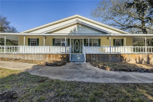 a front view of a house with a yard outdoor seating and yard