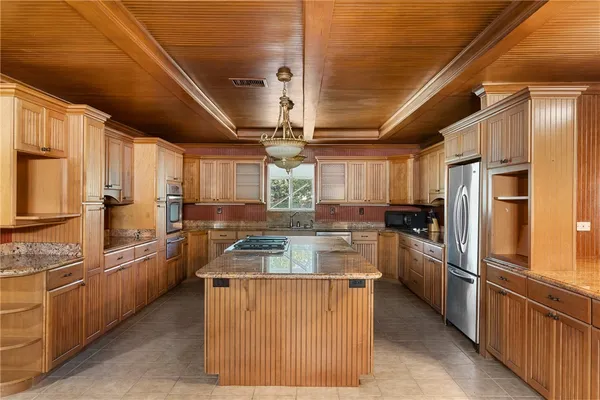 a kitchen with cabinets and stainless steel appliances
