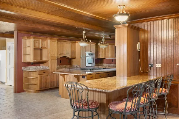 a kitchen with stainless steel appliances granite countertop a sink and a refrigerator