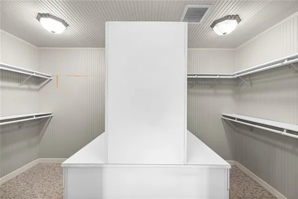 a view of a hallway with wooden floor and entryway