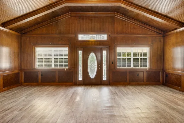 a view of a room with wooden floor and windows