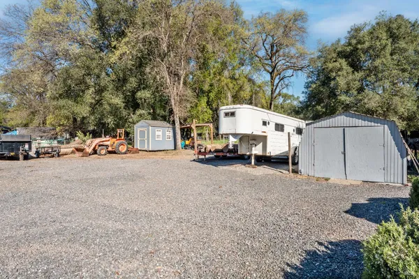 a white house that has a tree in front of it