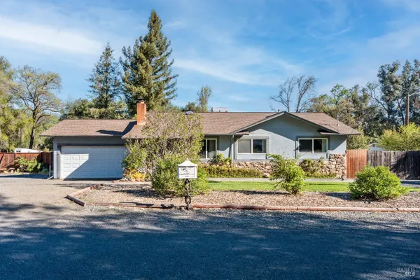 a front view of house with yard and green space
