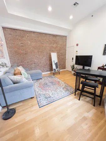 a bedroom with furniture and a rug