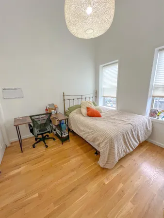 a bedroom with a bed a table and chair