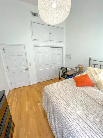 a bedroom with a bed and a mirror