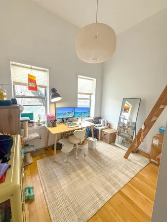 a view of a dining room with a table and chairs