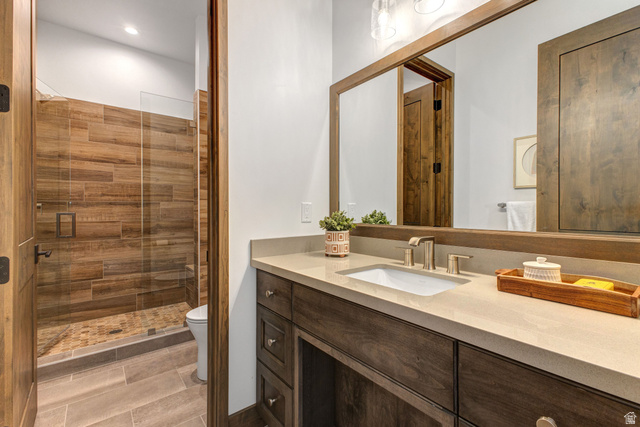 1282 Chimney Rock Road, Unit 344 Heber City, UT 84032 - Photo 46 of 55 Bathroom featuring a wood-finish vanity with an undermount sink and light-toned countertop