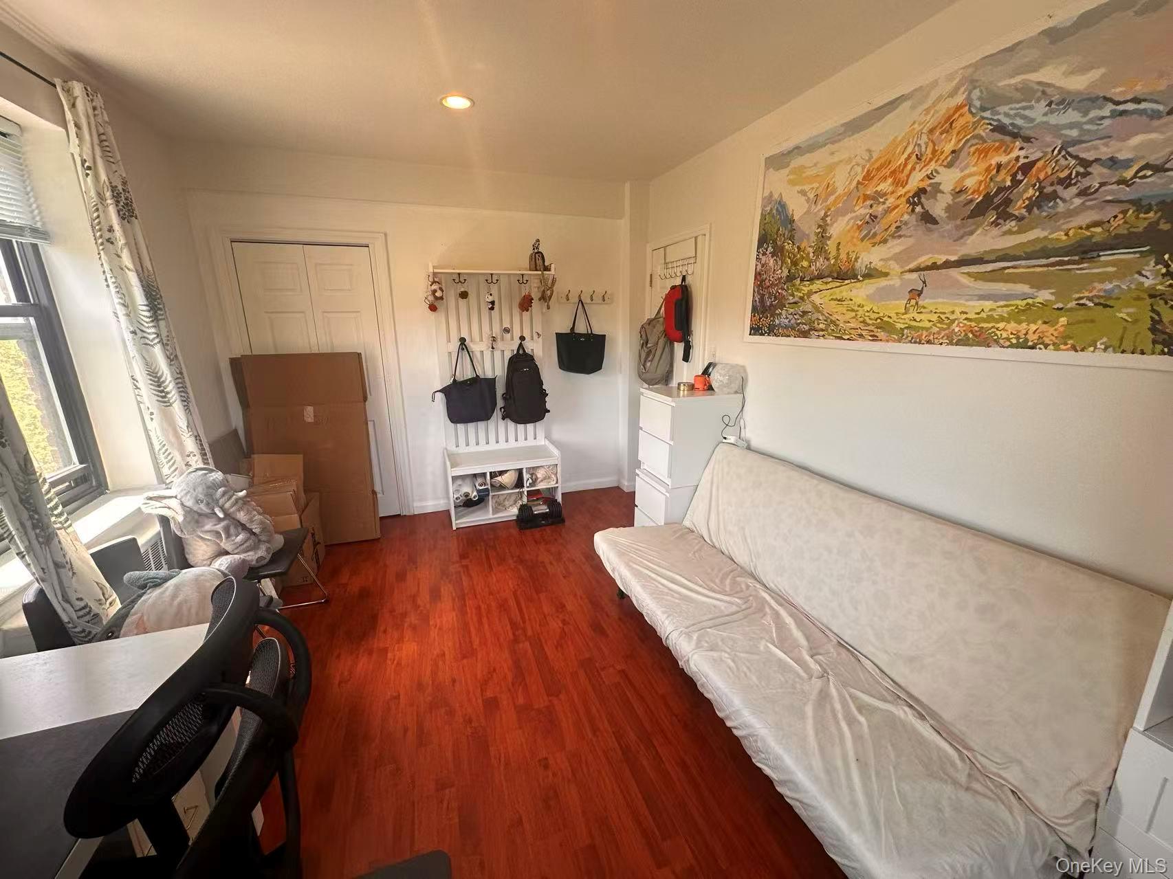 139-15 28th Road, Unit 6G Queens, NY 11354 - Photo 11 of 20 a living room with furniture and wooden floor