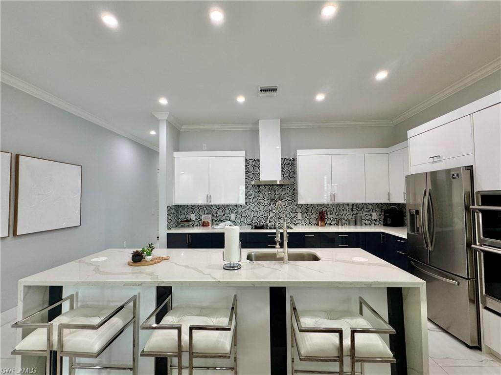 656 108th Avenue North Naples, FL 34108 - Photo 11 of 48 kitchen and Dining area featuring sink and ornamental molding
