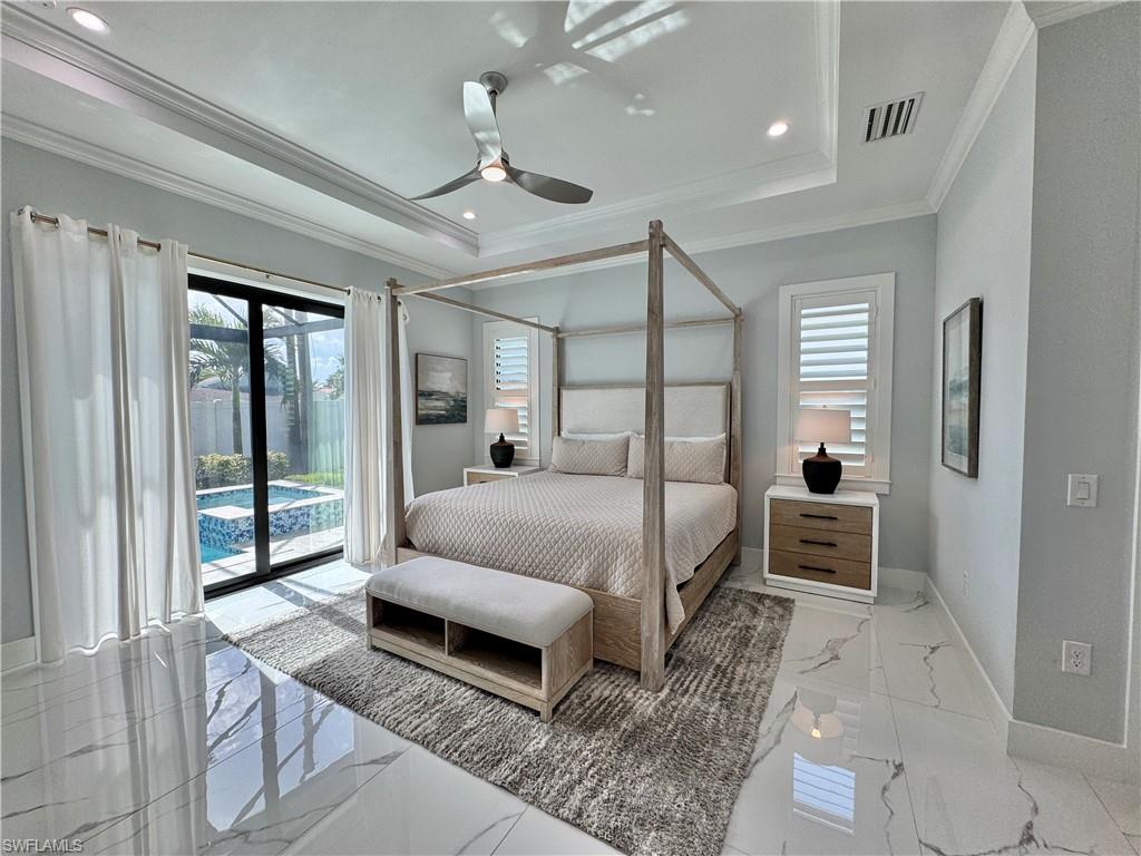 656 108th Avenue North Naples, FL 34108 - Photo 14 of 48 Bedroom featuring a tray ceiling, ornamental molding, and ceiling fan