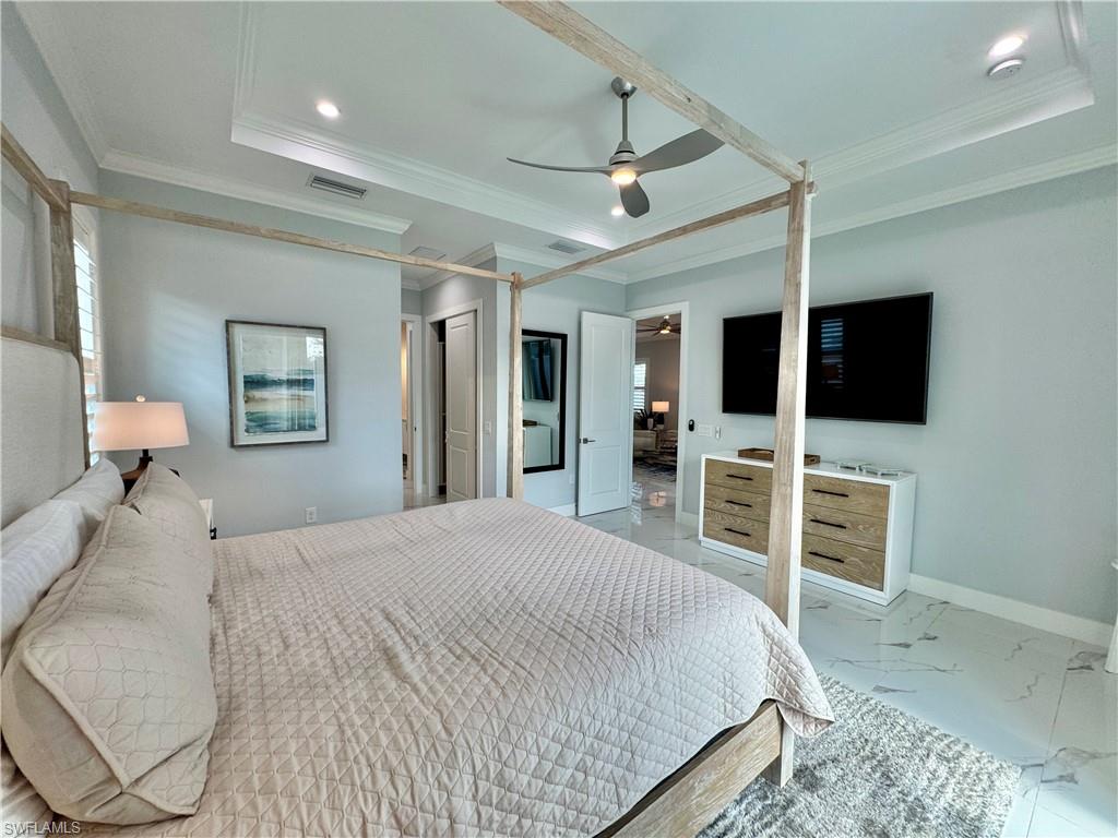 656 108th Avenue North Naples, FL 34108 - Photo 15 of 48 Bedroom with ceiling fan, ornamental molding, and a raised ceiling