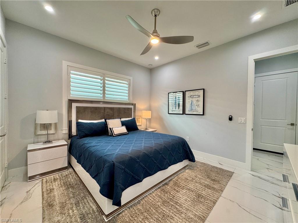 656 108th Avenue North Naples, FL 34108 - Photo 23 of 48 Bathroom featuring vanity, a shower with door, and toilet