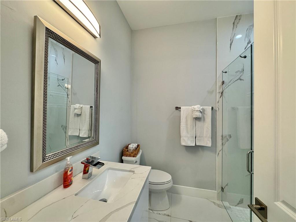 656 108th Avenue North Naples, FL 34108 - Photo 24 of 48 Bathroom with a shower with door