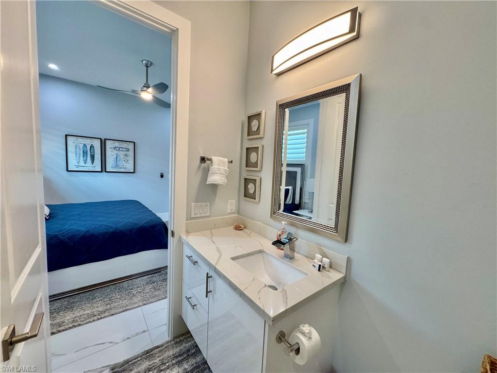 656 108th Avenue North Naples, FL 34108 - Photo 26 of 48 Bathroom featuring ceiling fan and vanity
