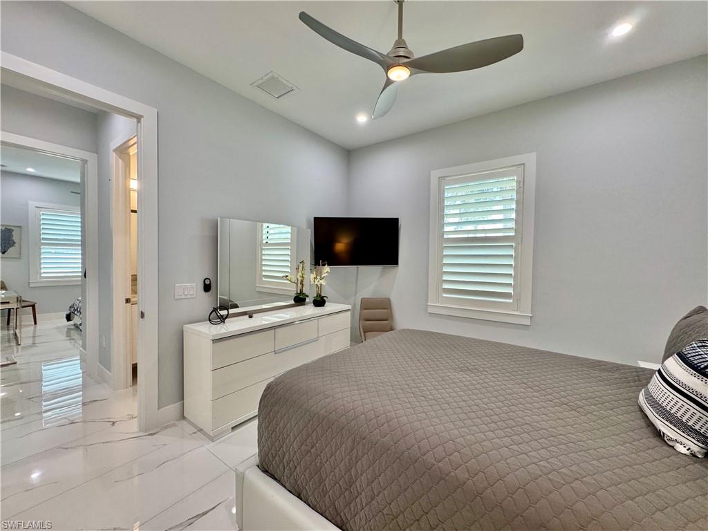 656 108th Avenue North Naples, FL 34108 - Photo 33 of 48 Bathroom with vanity, toilet, and a shower with shower door