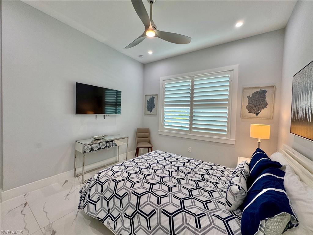 656 108th Avenue North Naples, FL 34108 - Photo 38 of 48 Bathroom with toilet, a shower with shower door, and vanity