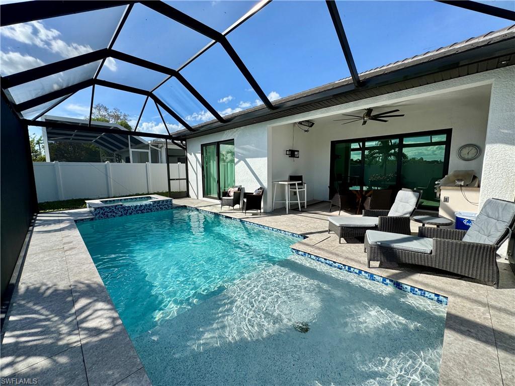 656 108th Avenue North Naples, FL 34108 - Photo 41 of 48 View of swimming pool featuring an in ground hot tub, a lanai, ceiling fan, and a patio area