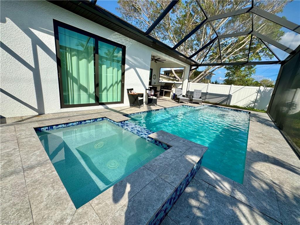 656 108th Avenue North Naples, FL 34108 - Photo 43 of 48 View of pool with a patio, a lanai, an in ground hot tub, and ceiling fan