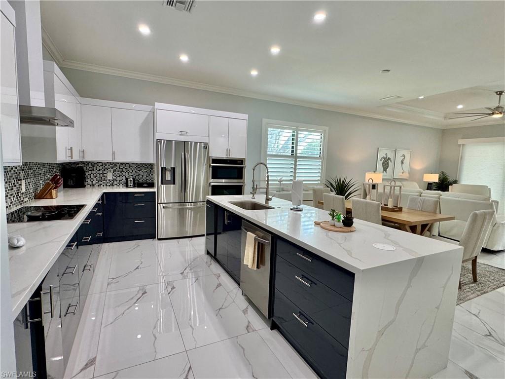 656 108th Avenue North Naples, FL 34108 - Photo 6 of 48 Dining room featuring sink and ornamental molding
