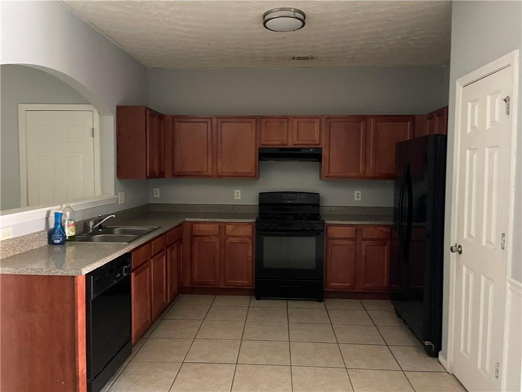 1538 Viero Drive Duluth, GA 30096 - Photo 3 of 8 a kitchen with a sink a stove and cabinets