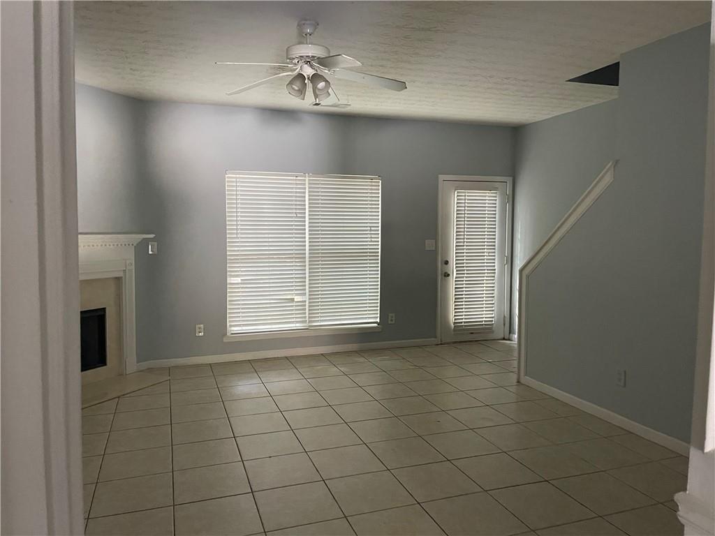 1538 Viero Drive Duluth, GA 30096 - Photo 4 of 8 a view of an empty room with a fireplace and a window